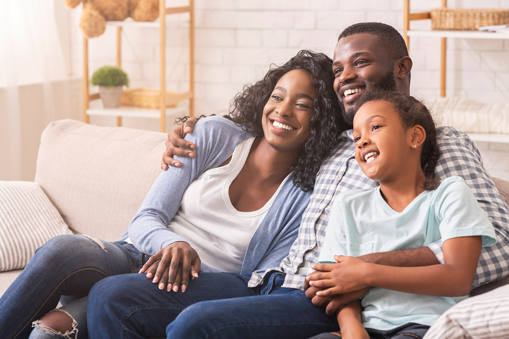 father-mother-daughter-sitting-smiling